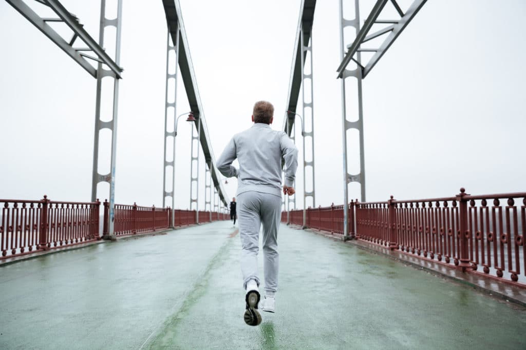 Man running on bridge