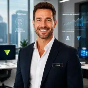 Smiling man in a navy blazer with a name tag reading STAN, standing in front of holographic business dashboards in a modern office.
